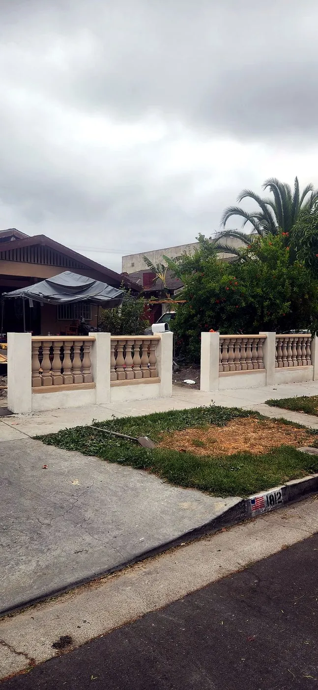 Before: unpainted concrete balustrade fence