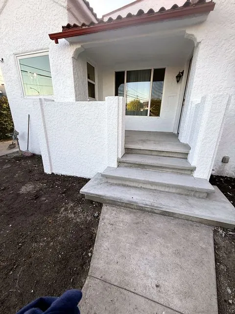 White stucco porch with new concrete steps