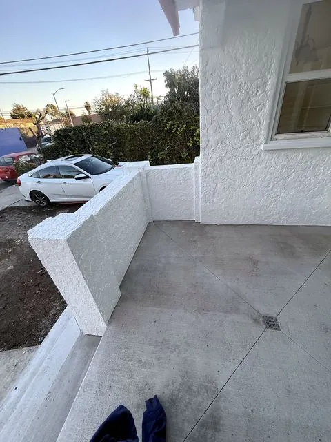 White stucco porch wall and concrete floor