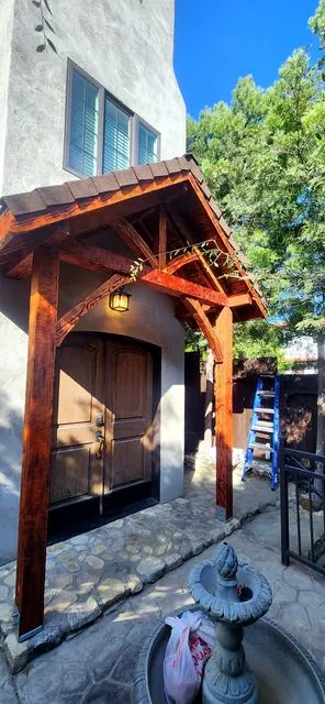 Stained timber portico over a front door