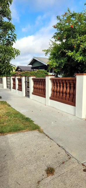 Brown balustrade fence with white pillars